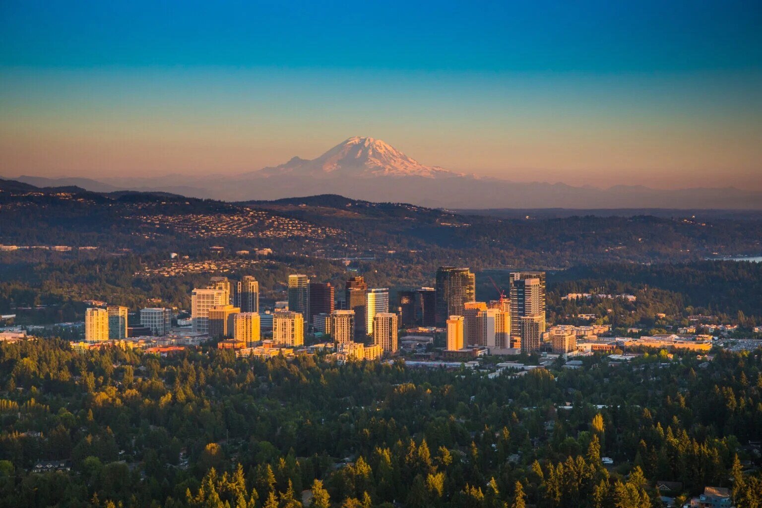 Bellevue skyline at dusk with mountains beyond