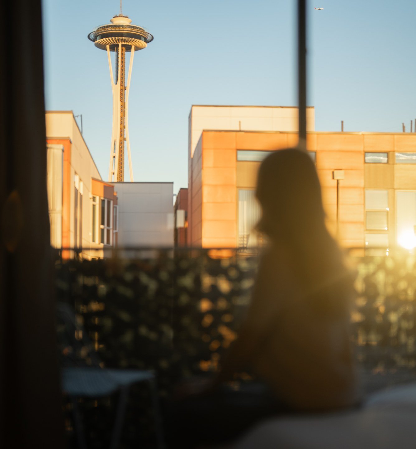 Guest looking out at the Seattle skyline at sunset
