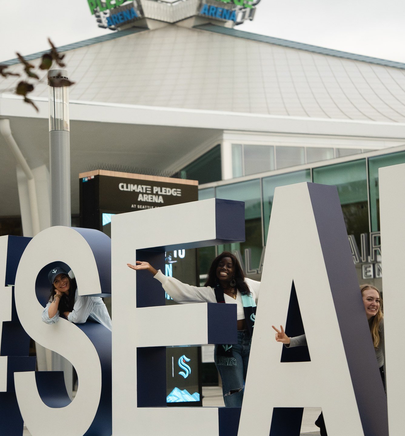 Guests at the SEA letters outside Climate Pledge Arena