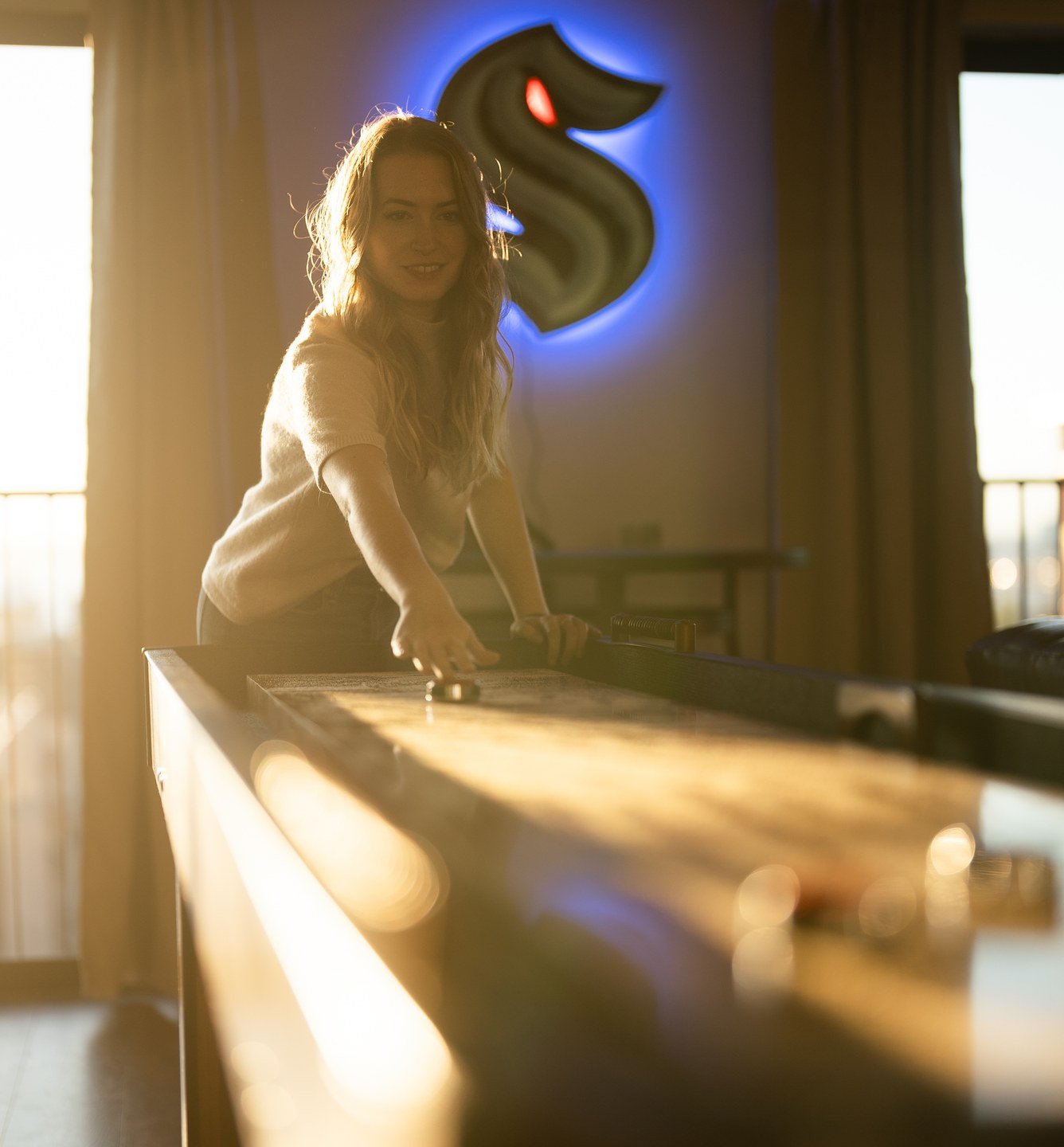 Guest playing shuffleboard in a 29 Nights home